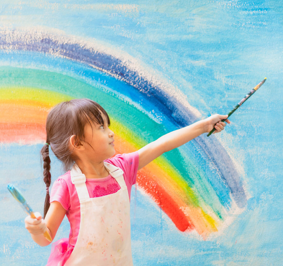 Banner of asian little girl is painting the colorful rainbow and